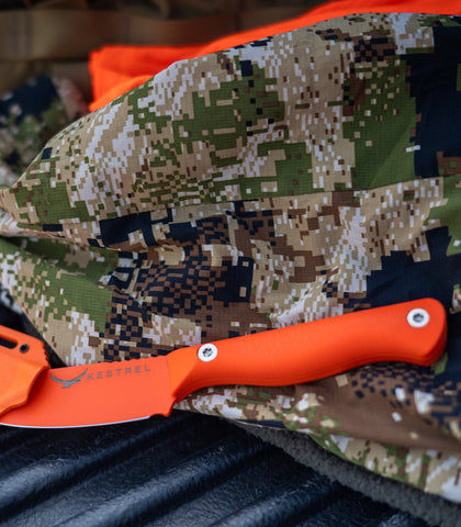 Kestrel Ovis Hunter S.E. in orange with sheath on a camo jacket